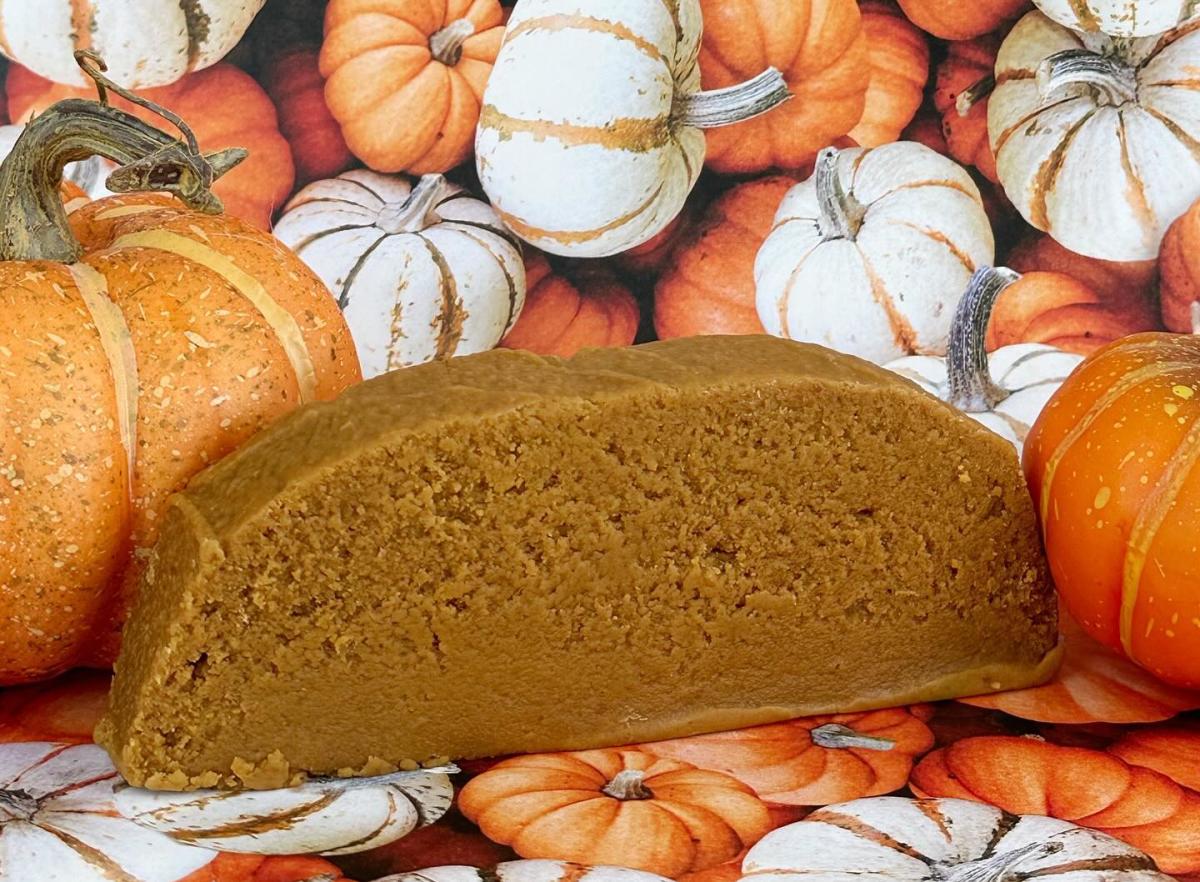 A slice of creamy, Mackinac Island fudge sits among a collection of pumpkins