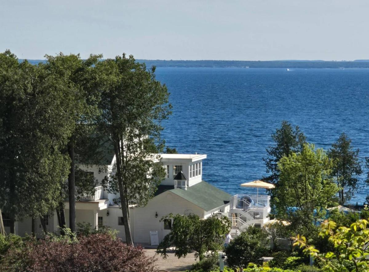 Deep blue waters beyond a cottage on the shore of Mackinac Island