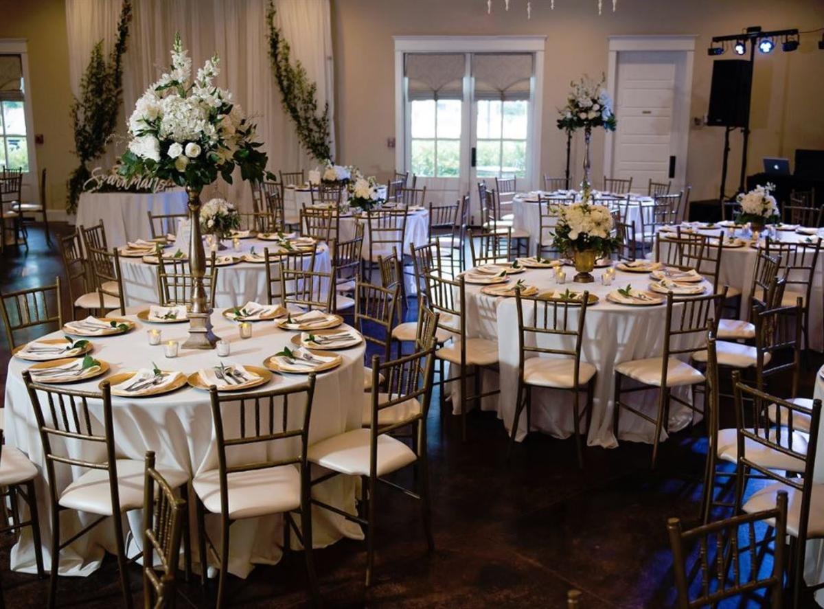 The Laurels Meeting Area With Flower Arrangement And Round Tables
