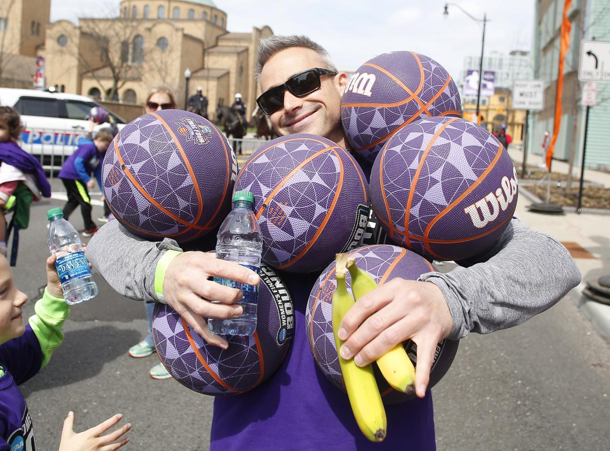 Volunteer holding basketballs