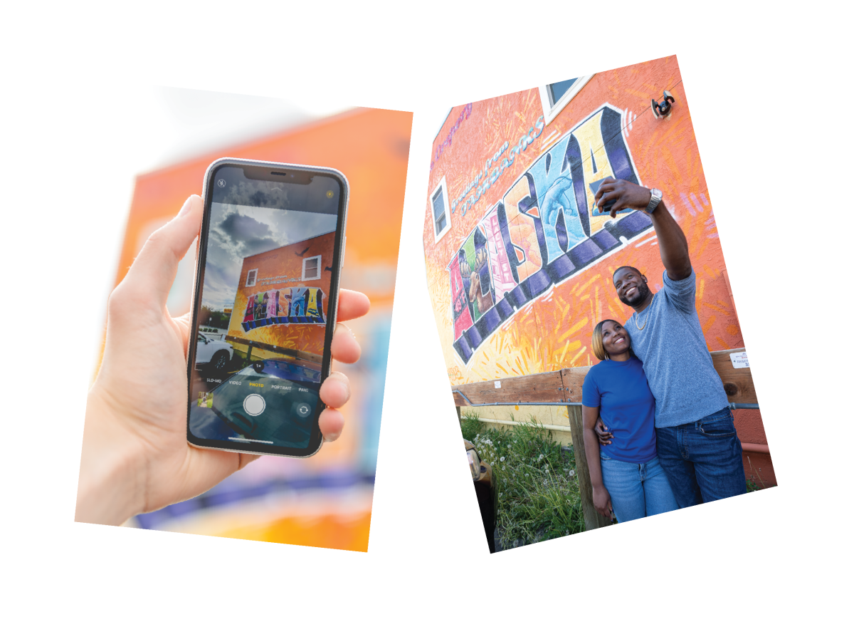 A collage with two images. On the left, a hand holds a smartphone taking a photo of the mural; on the right, a smiling couple stands in front of the same mural, taking a selfie together outdoors.