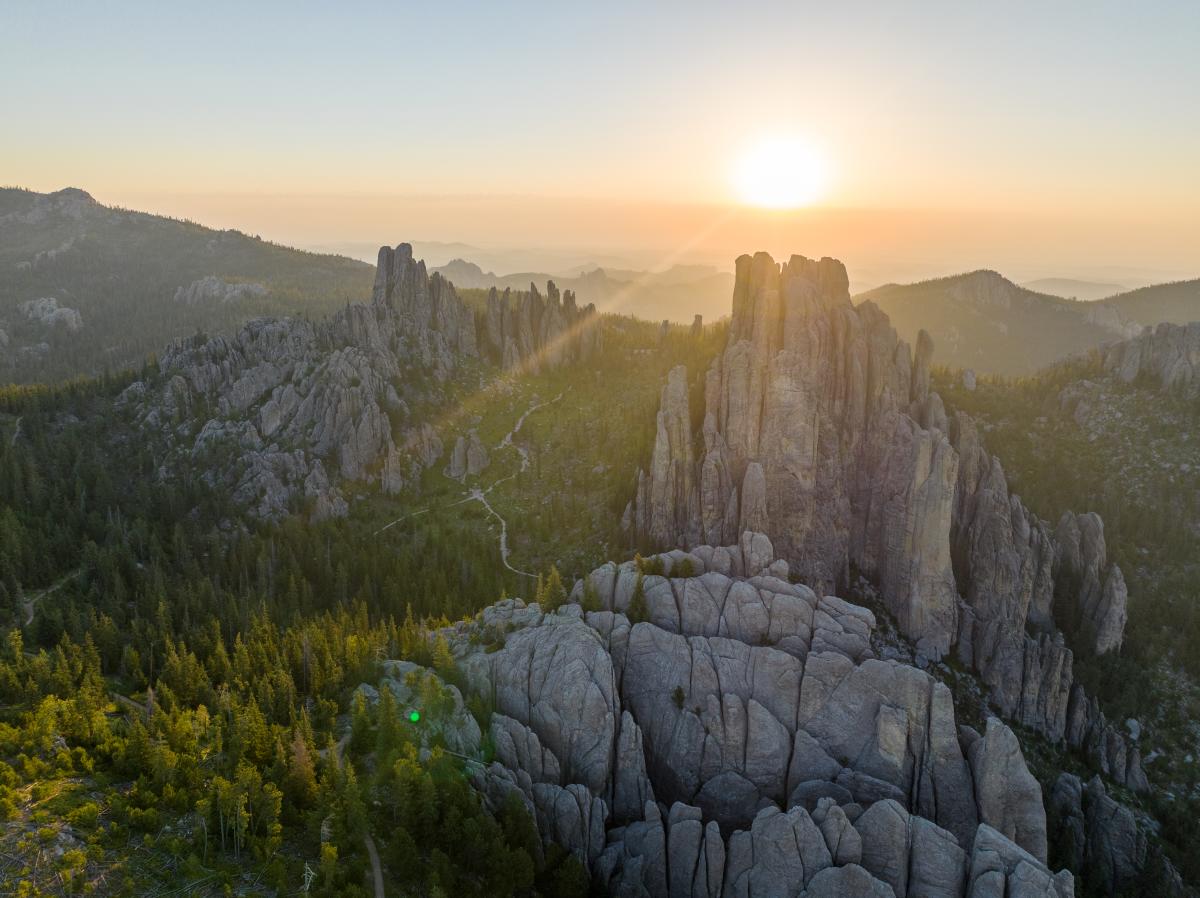 sun rays over the needles of needles highway in custer state park in south dakota
