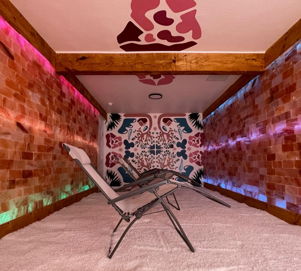 Inside the Austin Salt Room with reclining chairs and salt covering the floor and walls.