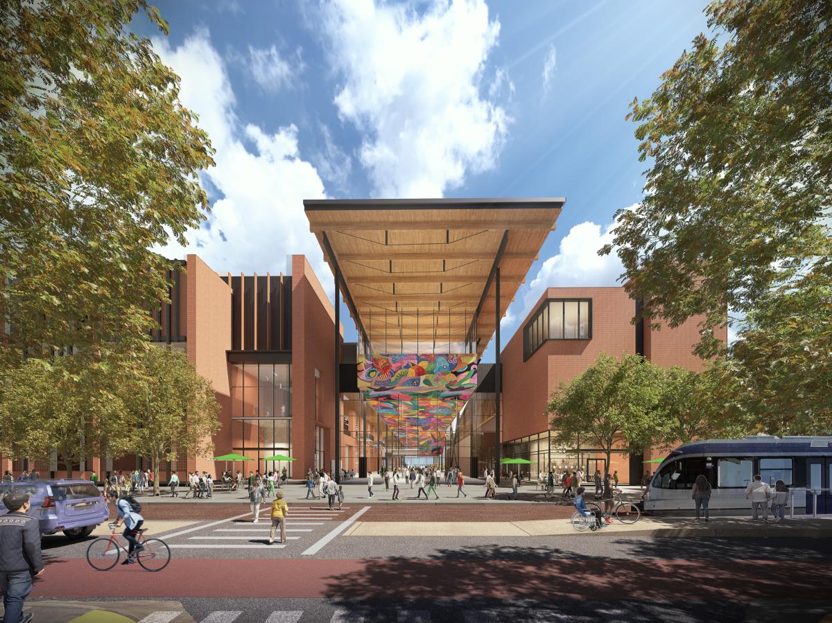 Austin Convention Center rendering showing the new building's West Entrance from street level with pedestrians, cyclists and a light rail along the street. The multi-story building includes a mural along the ceiling of the entrance