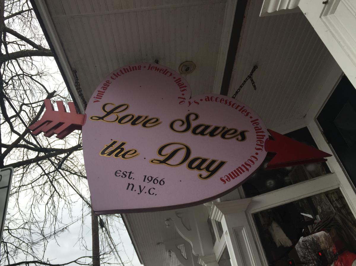 Love saves the day sign