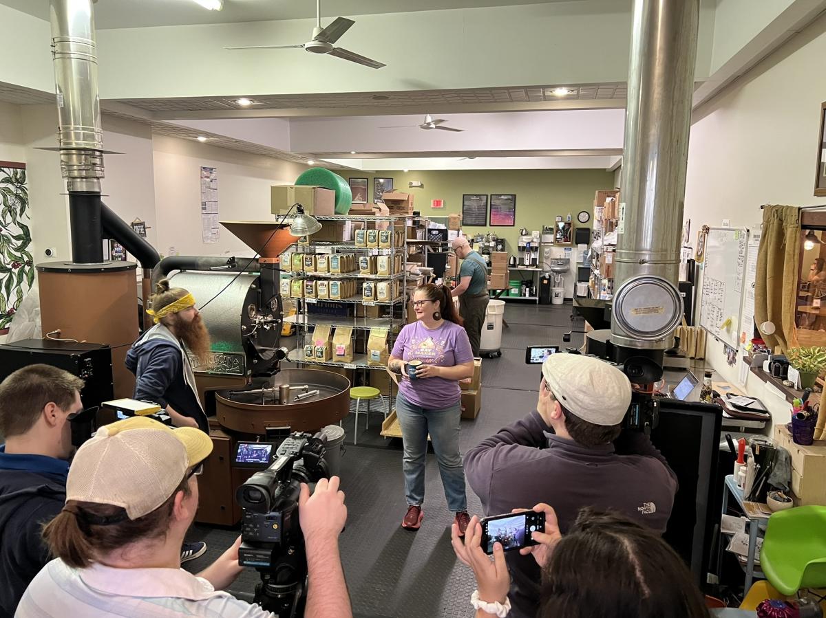 reporters film inside a coffee roastery