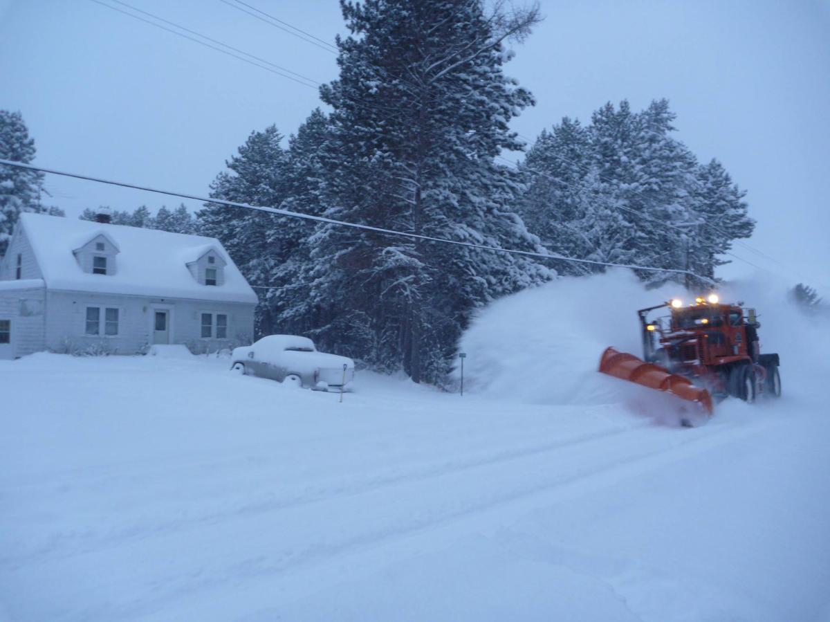 Snow Plow clears street.