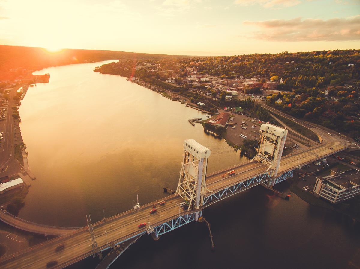 Aerial shot of Portage Lake Lift Bridge at sunset in fall