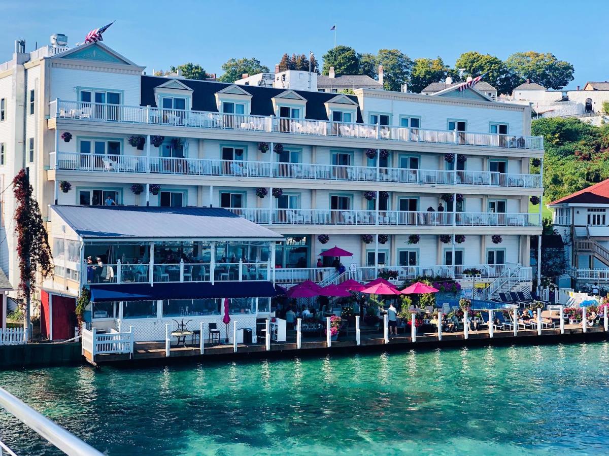 The back of Mackinac Island’s Chippewa Hotel with pink umbrellas along the waterfront