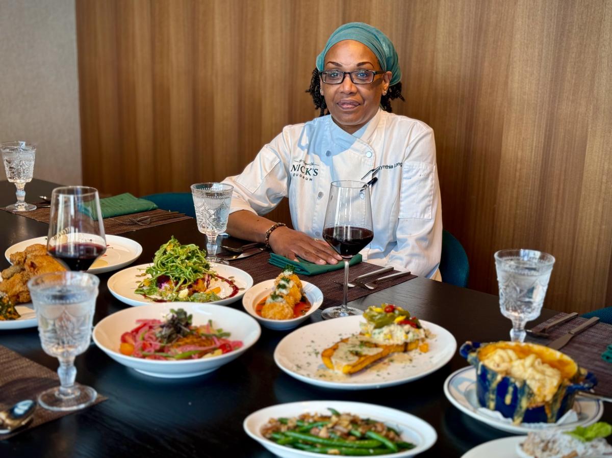 A Nick's Quorum restaurant chef with plates of food.