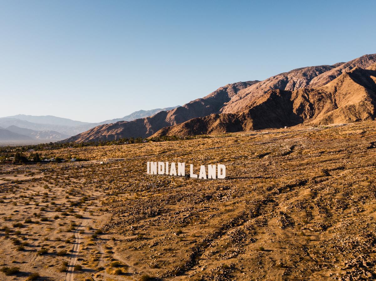 Indian Land letters in the desert with mountains