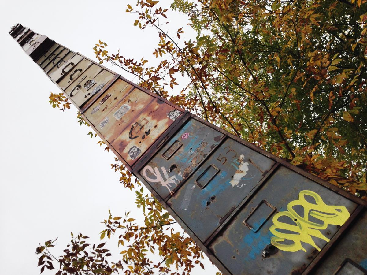Photo looking up at the World’s Tallest Filing Cabinet with trees in the background emphasizing the height of the tower