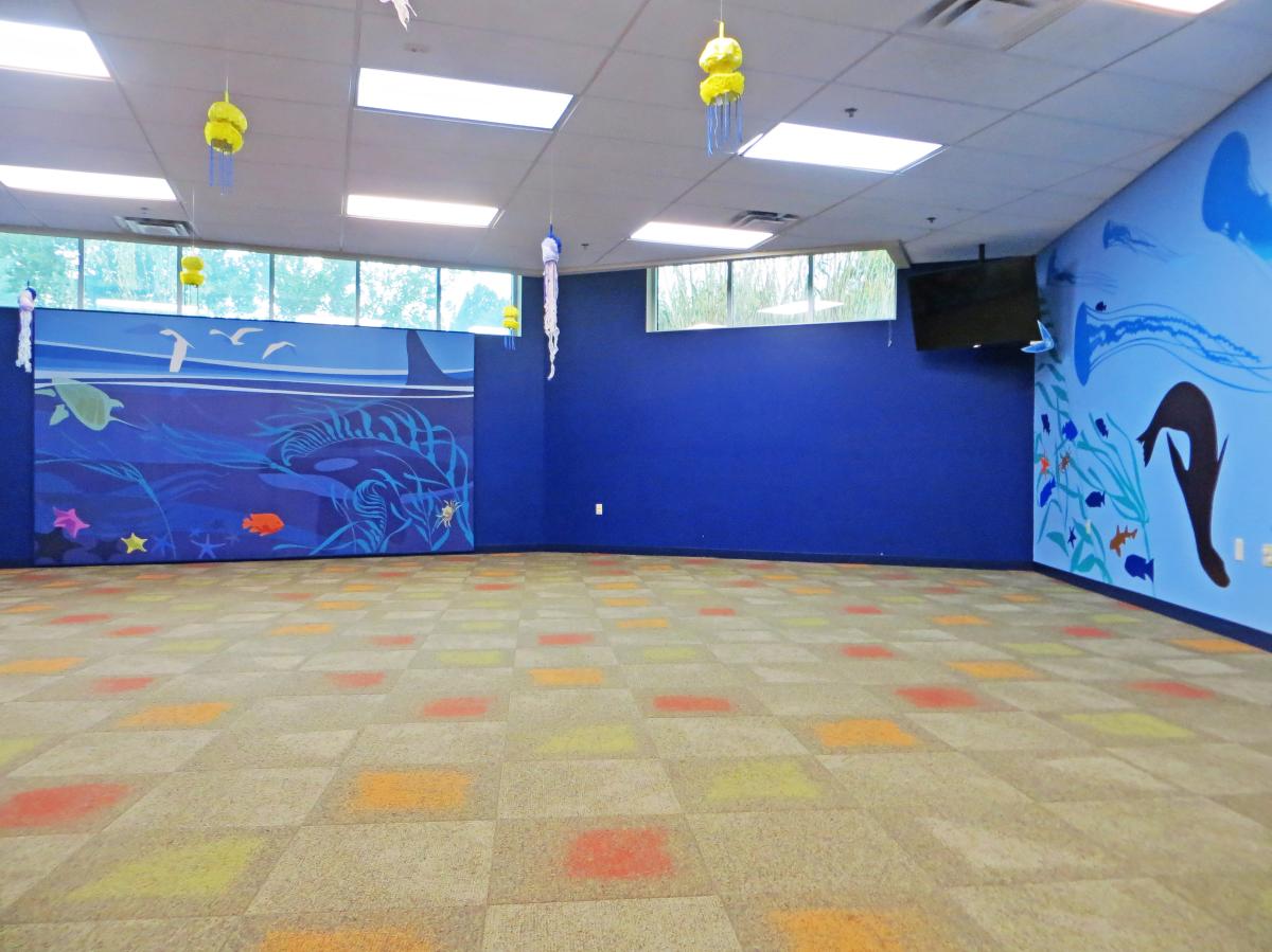 A meeting room sits available painted with blue walls and sea animals at Sedgwick County Zoo