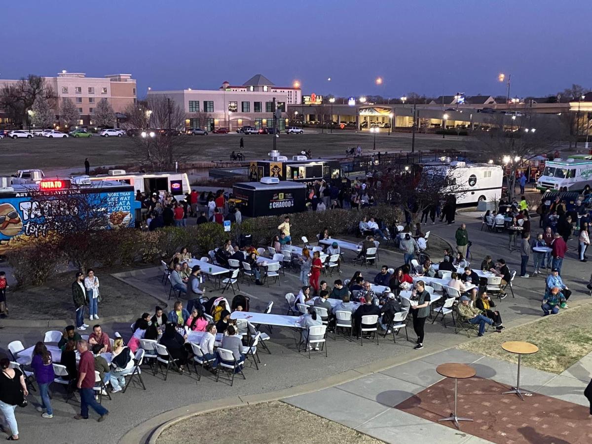 People line up to taste food from food trucks at the Final Friday Food Truck Rally in downtown Wichita