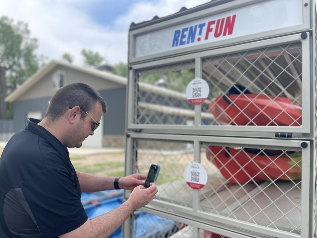 A man rents a Kayak at a kiosk in Wichita