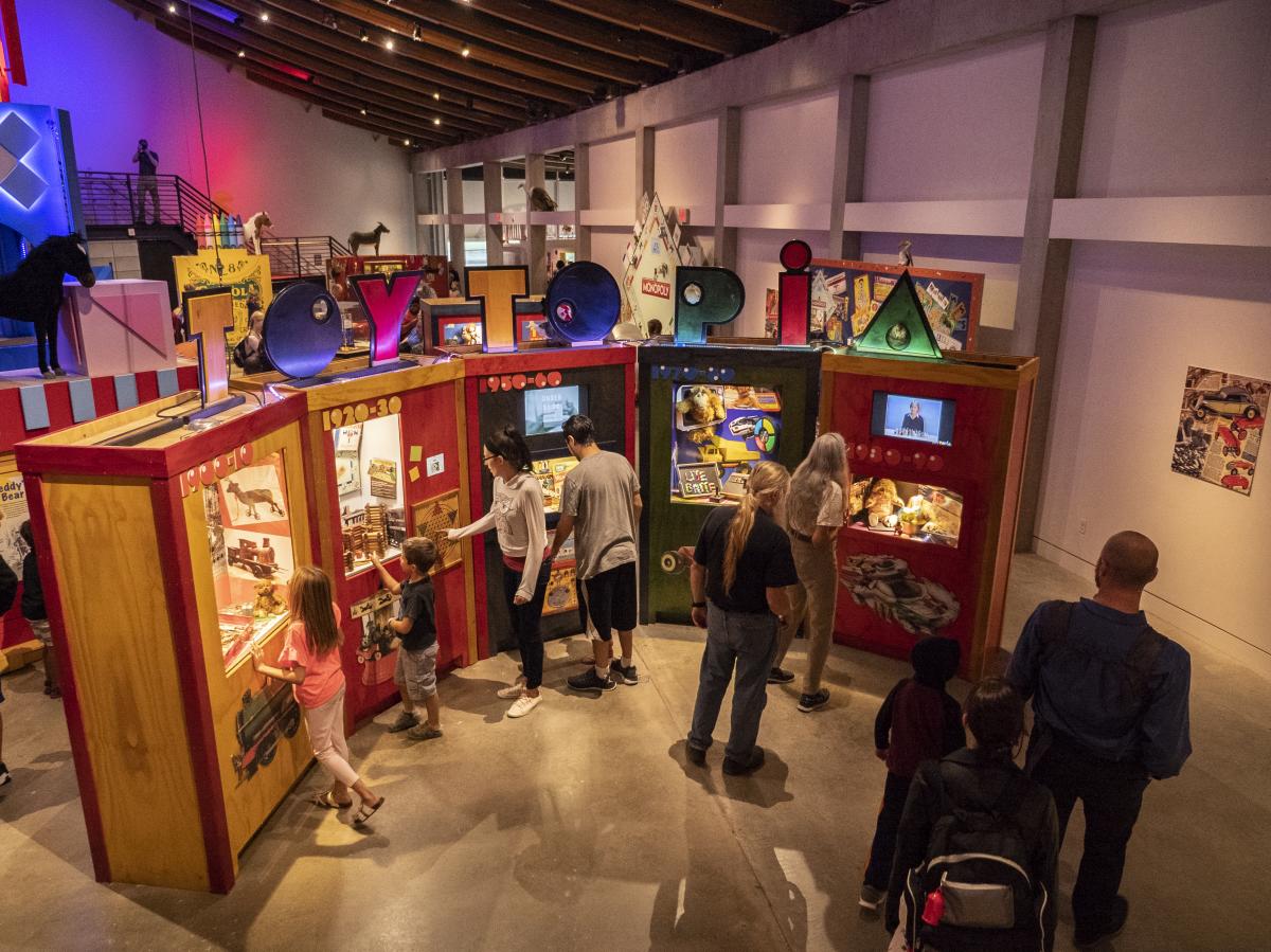 Visitors play with the interactive Toytopia exhibit at Exploration Place