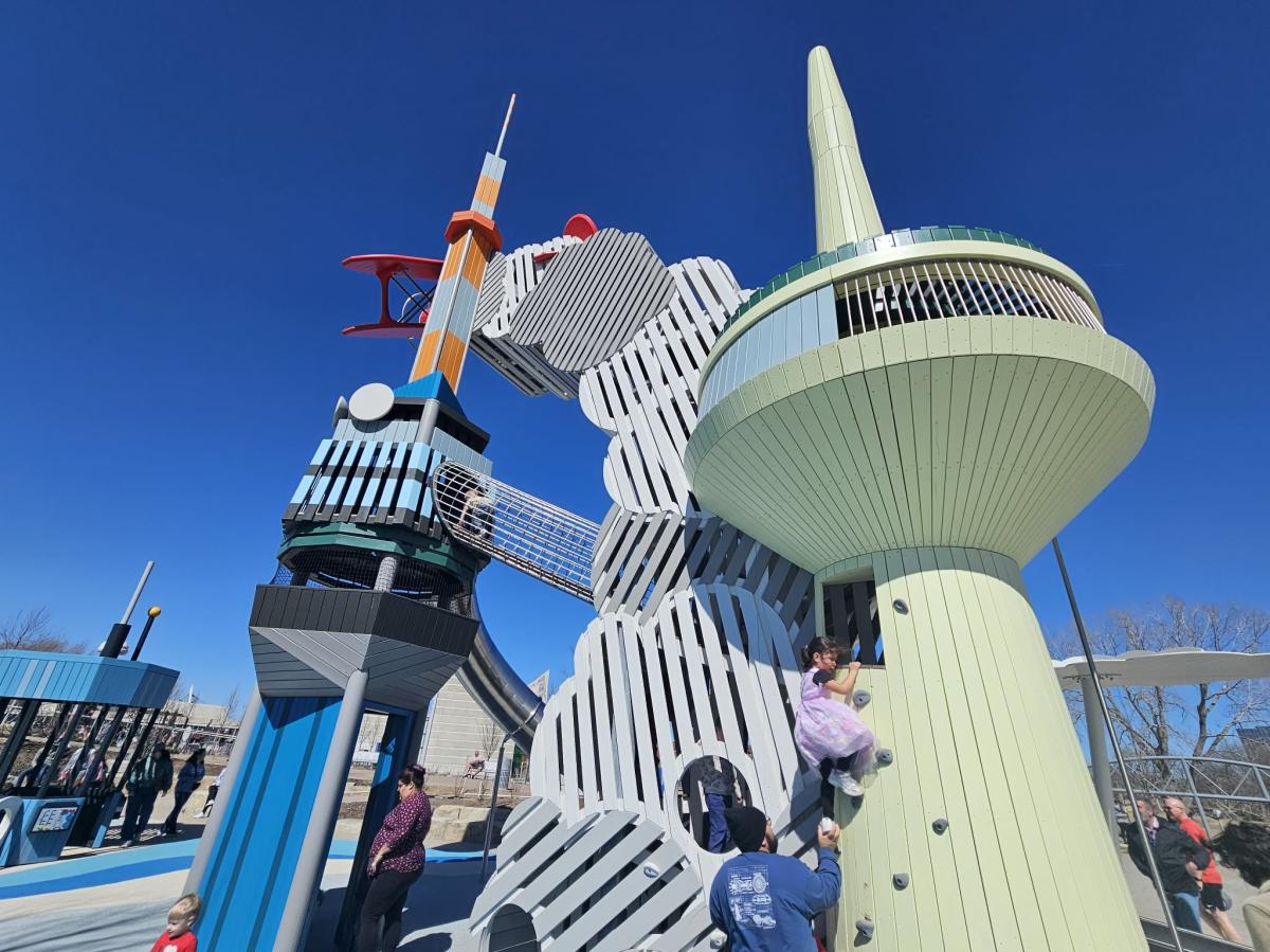 Kids climb on an airplane tower structure at Adventure Playscape
