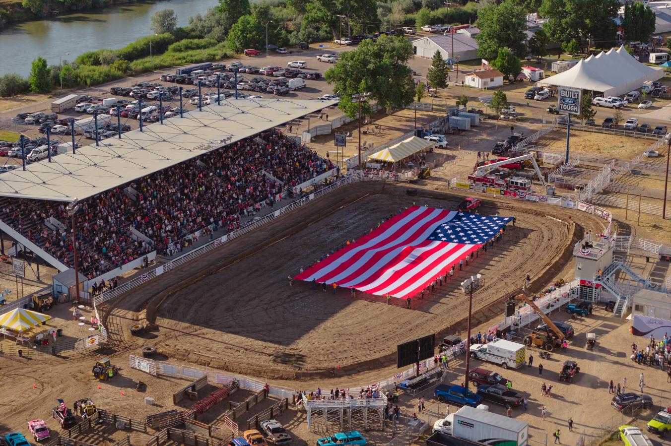 An American flag in the middle of the Wyoming State Fair grounds during a rodeo.