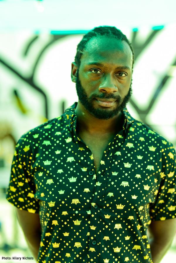 Musician Ki5 with serious look and green lighting