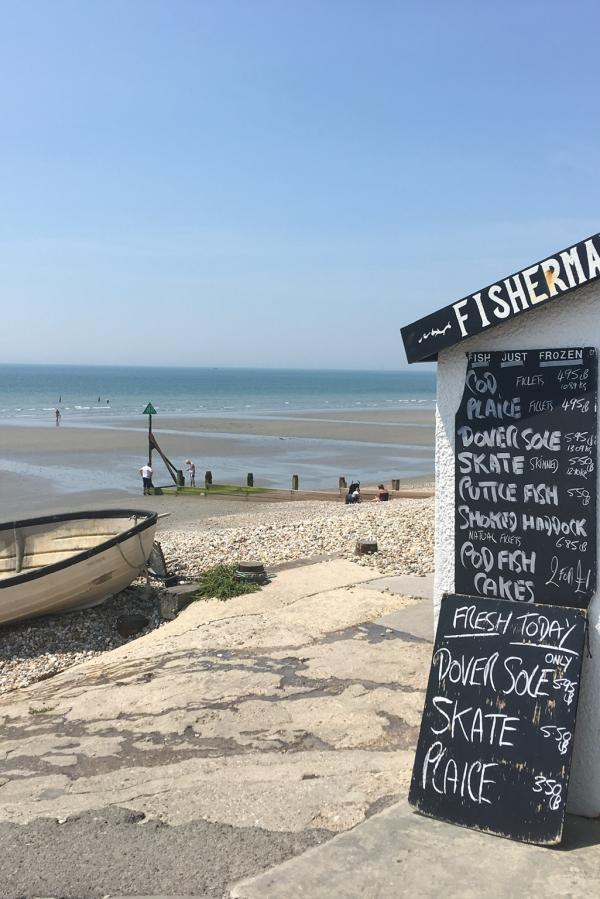 a view of east wittering beach with seafood hut