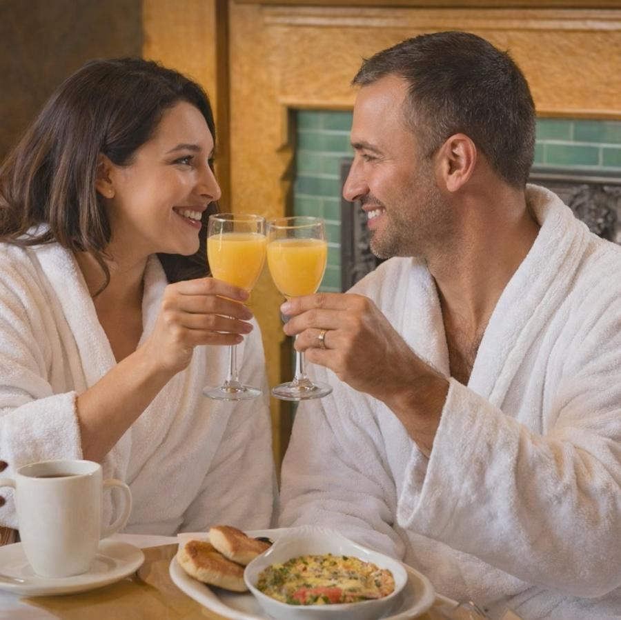 Couple having breakfast in robes