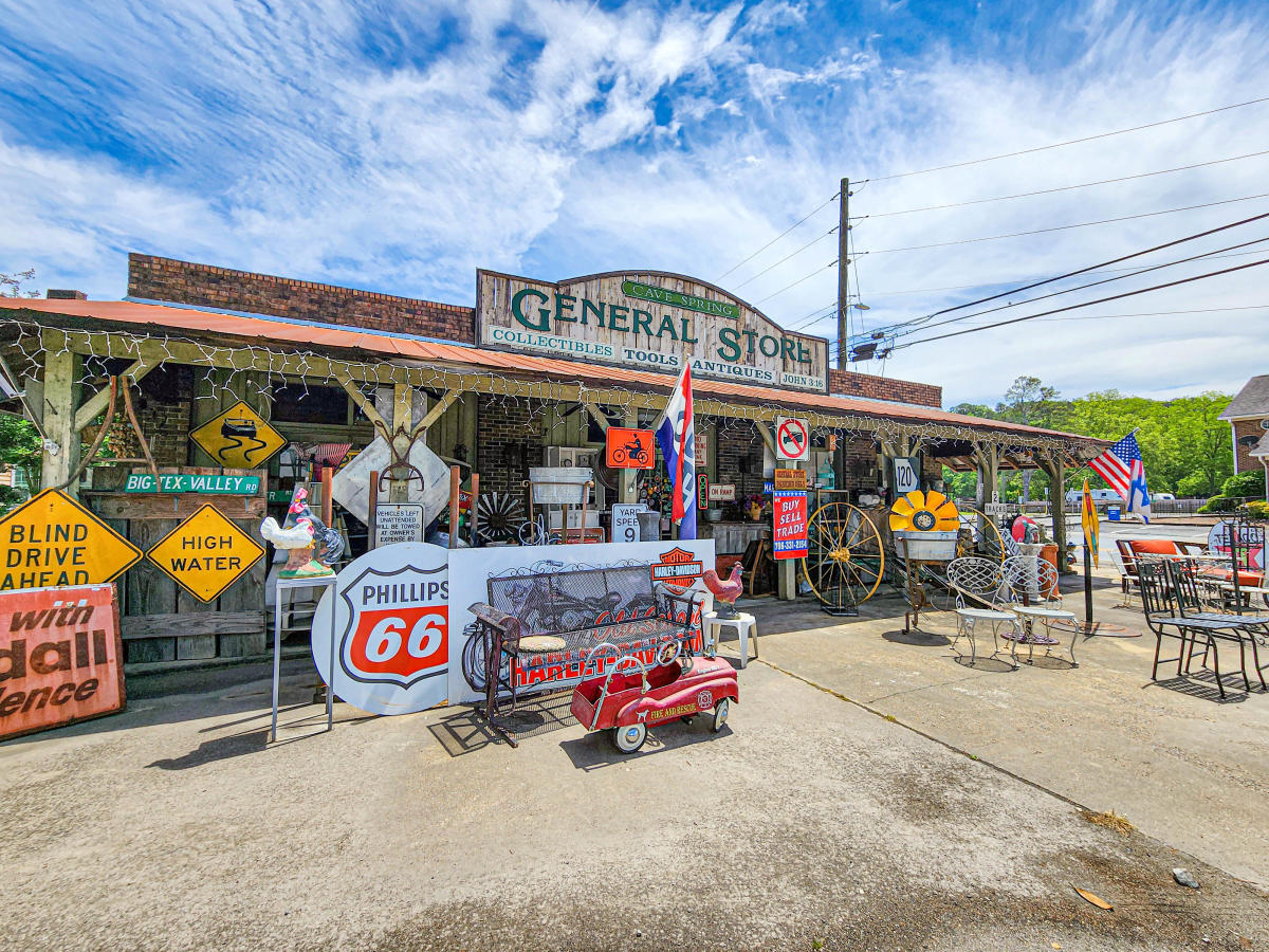 Old country general store covered in vintage signs and flags.