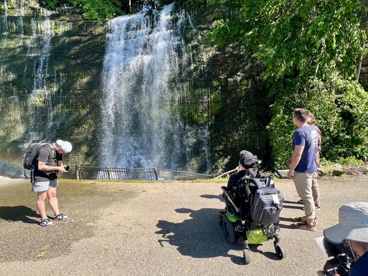 Cory Lee fiming with TJ and Clayton in front of Waterfall