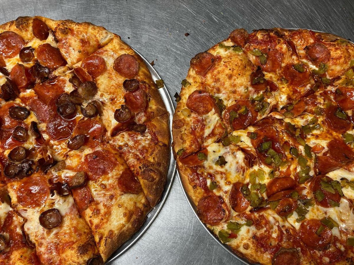 Two pizzes from JC's New York Pizza Department.