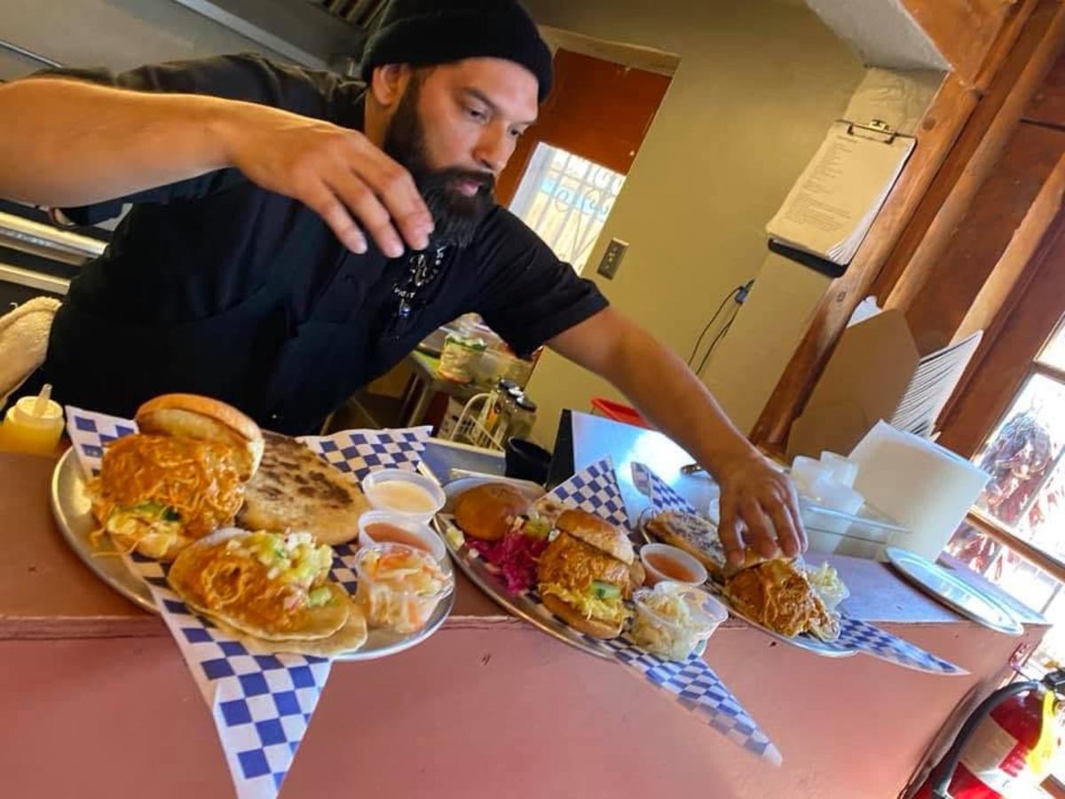 Chef Nestor prepares three plates of food at Gobble This.