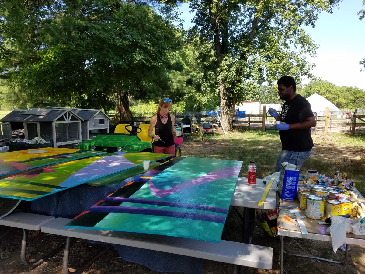 Farmhand Ron McCrary helps Cindy paint