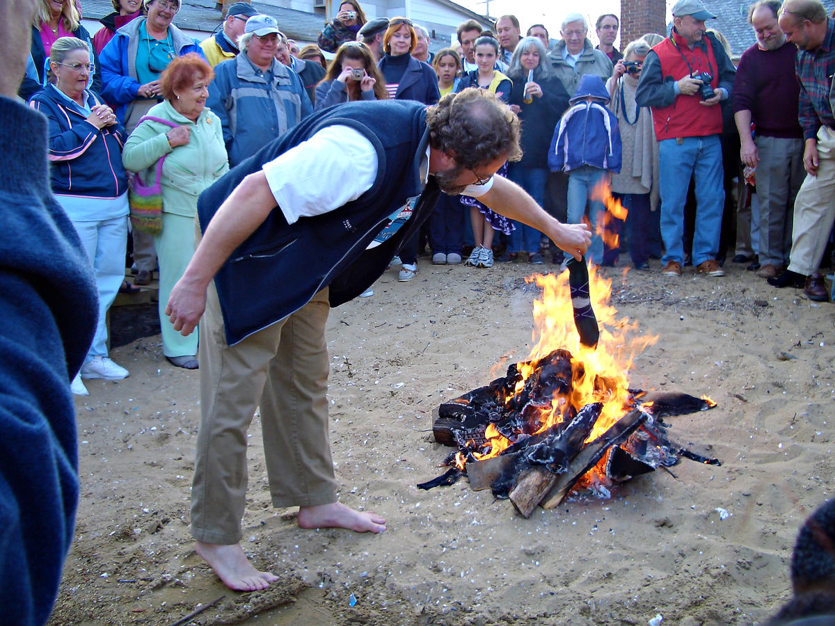 Man burning socks at fire pit