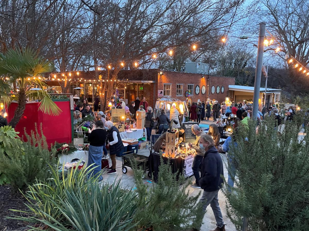 A holiday market outside Big City Bread at twilight.