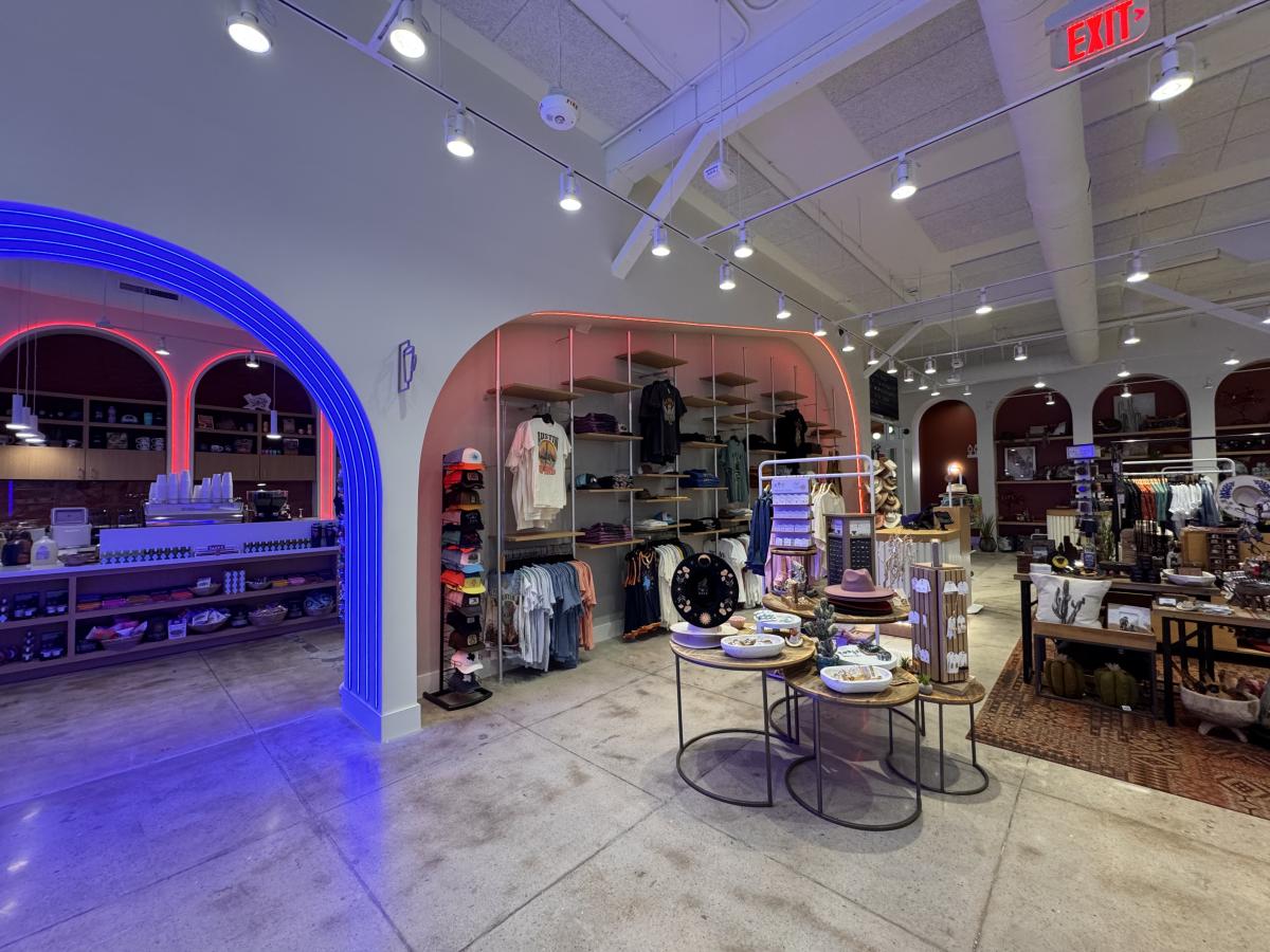 Austin Visitor Center retail space with displays and neon lights.