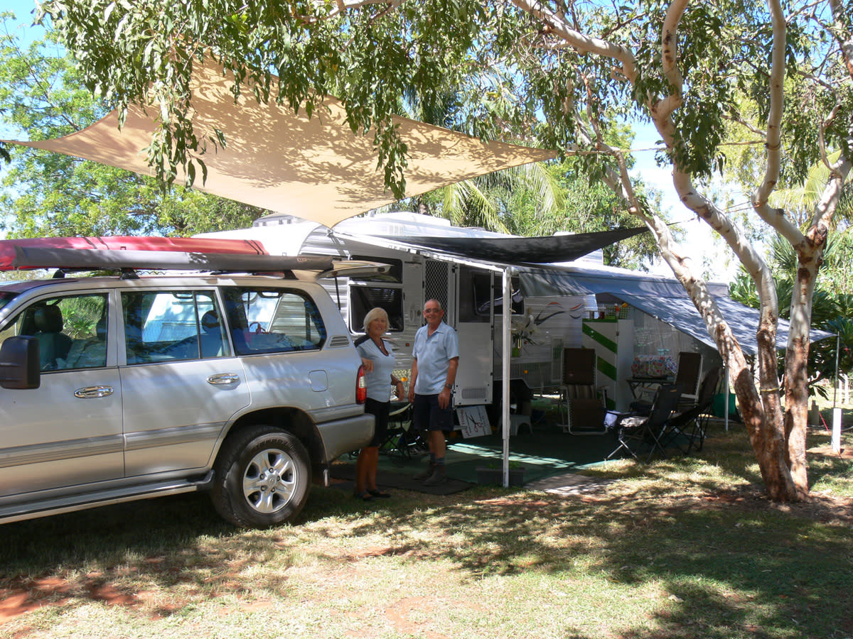 Shady caravan site and happy campers at Tarangau Caravan Park