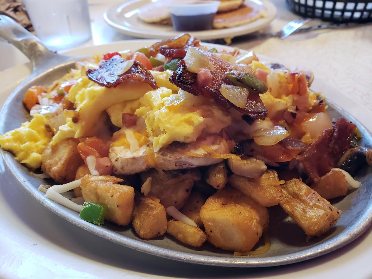 hearty breakfast skillet with eggs, potatoes, bacon and vegetables at Chase's Diner in Chandler AZ