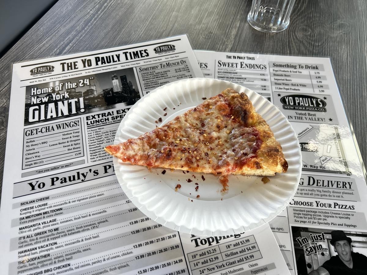 Yo Pauly's pizza slice on top of menu.
