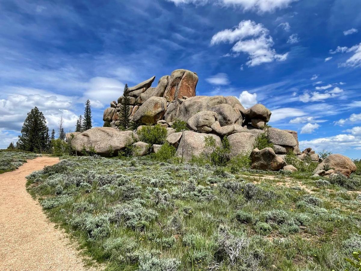 Unique rock formations at Vedauwoo, a popular spot for outdoor climbing and rock climbing near Cheyenne, Wyoming, under a bright blue sky.