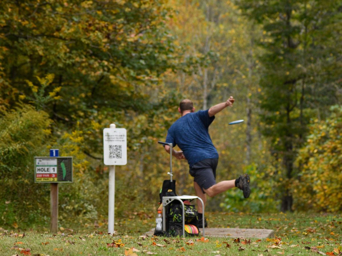 Man throwing disk golf at Rotary Park