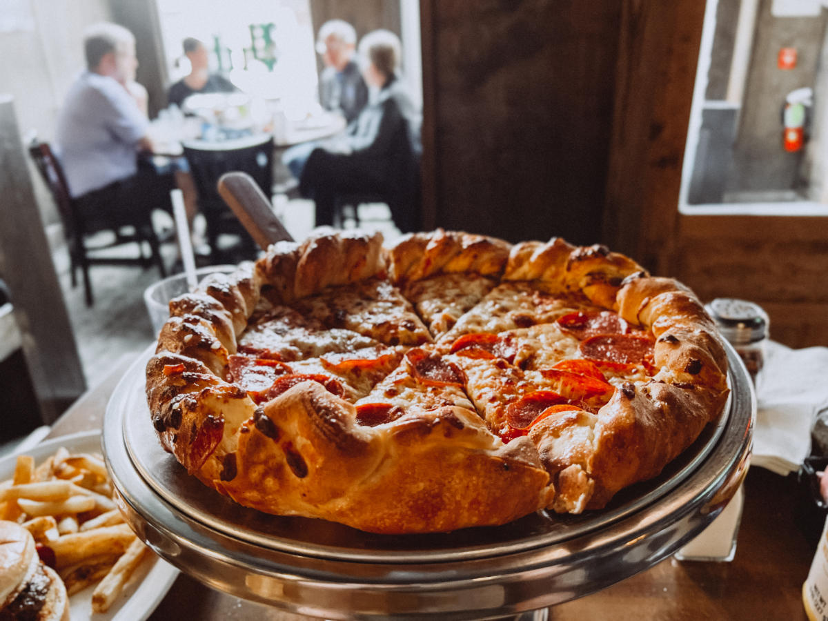 pizza with people in the background