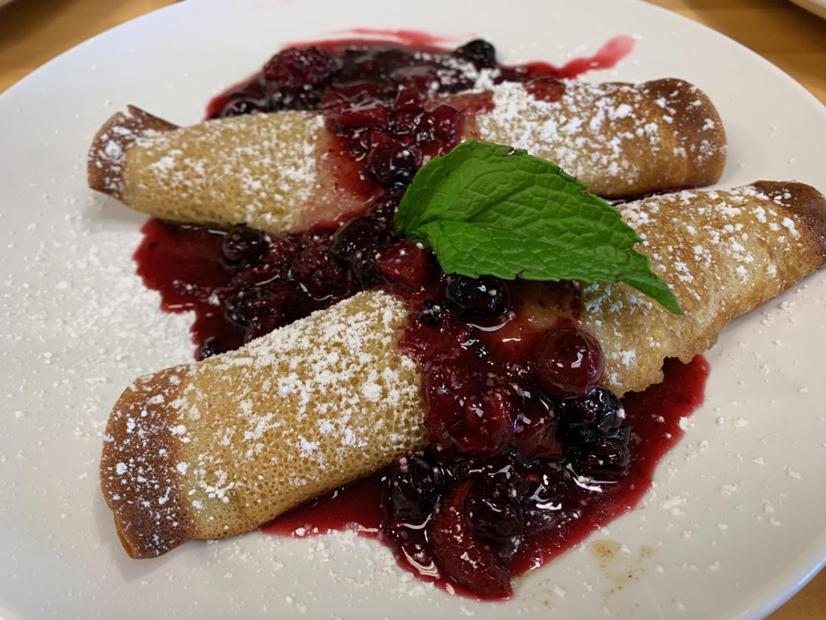 Berry crepes from Cafe Elena are topped with powdered sugar.