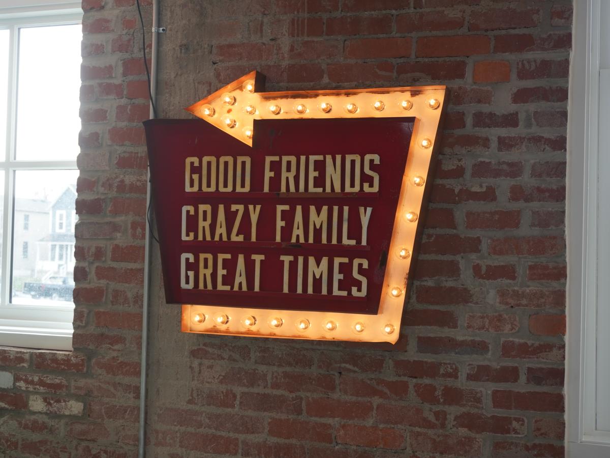 Budd Dairy sign directing to good friends, crazy family, great times