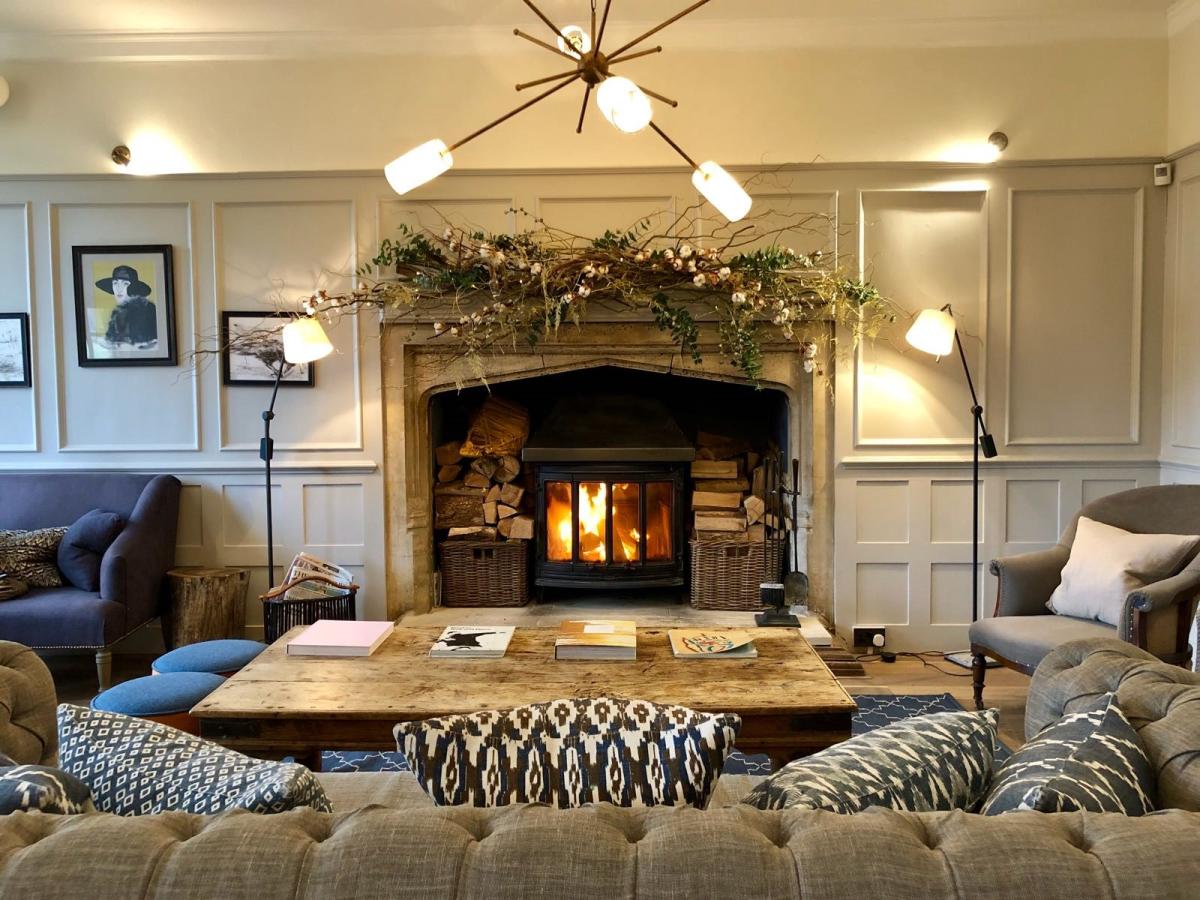 Festively decorated fireplace surrounded with sofas in the lounge of The Painswick