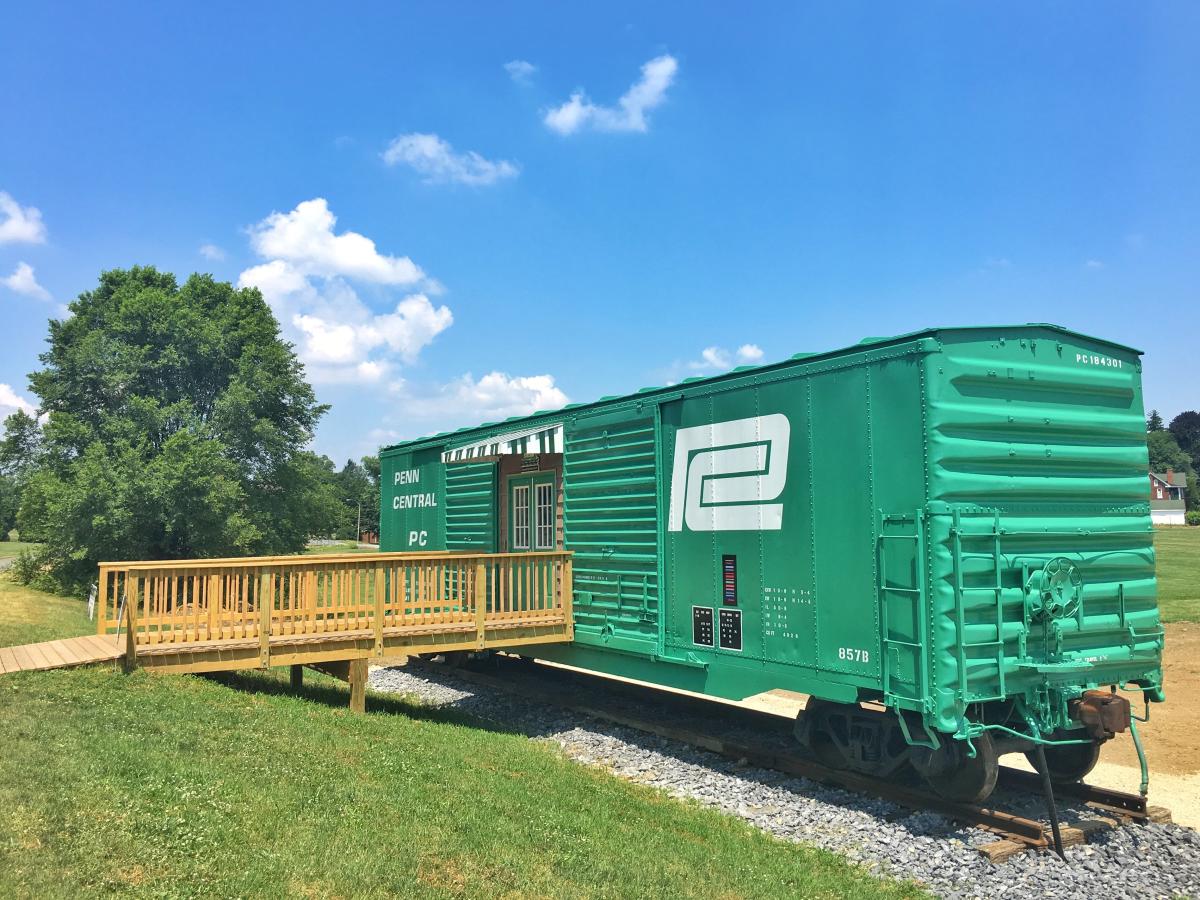 Train car on display outside at museum