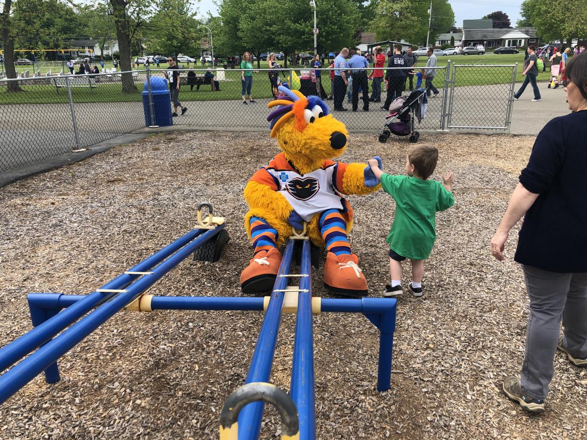 meLVin, the mascot of Lehigh Valley Phantoms hockey high fives a child at a playground