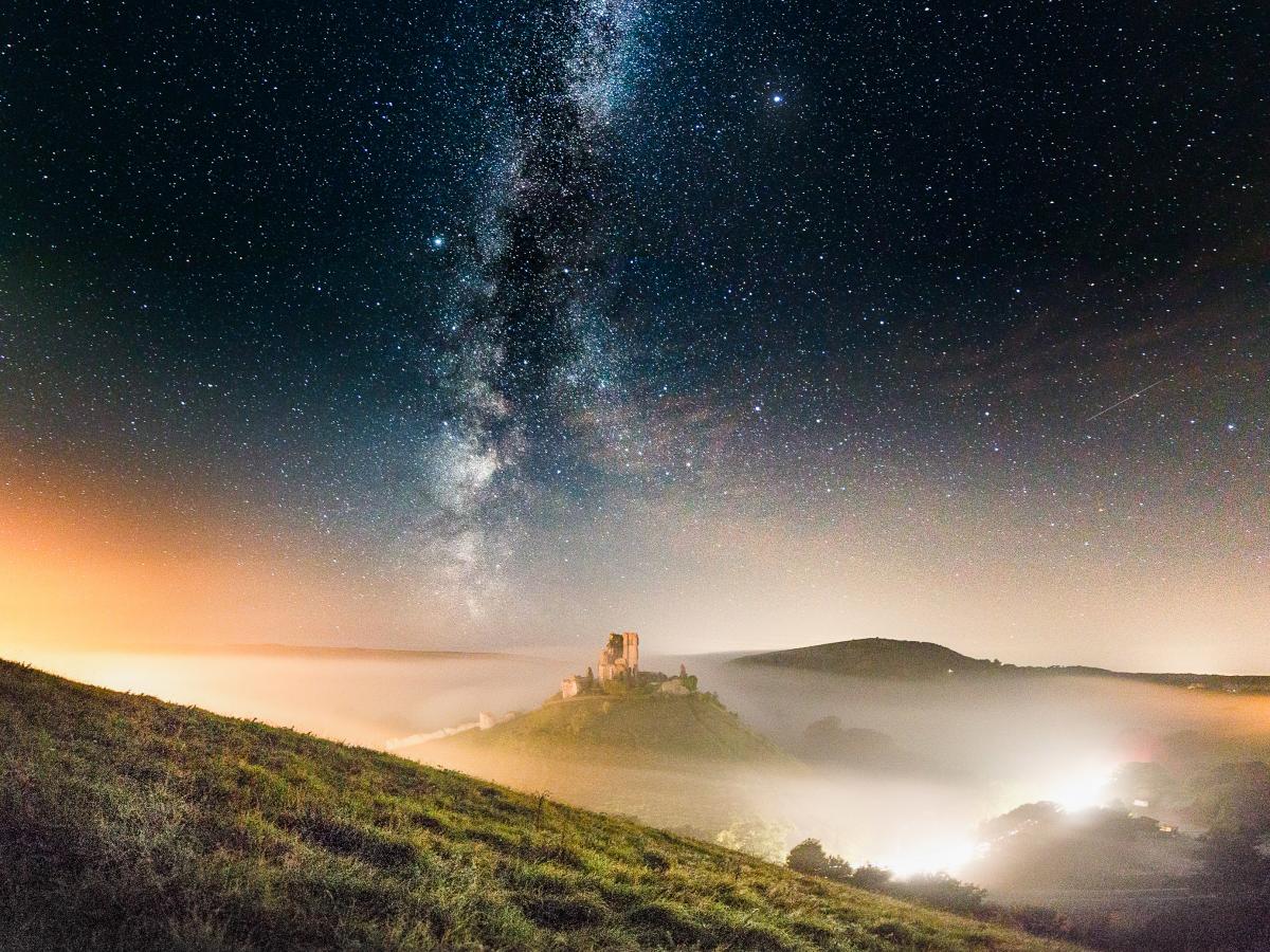 Corfe Castle in the mist and the Milky Way