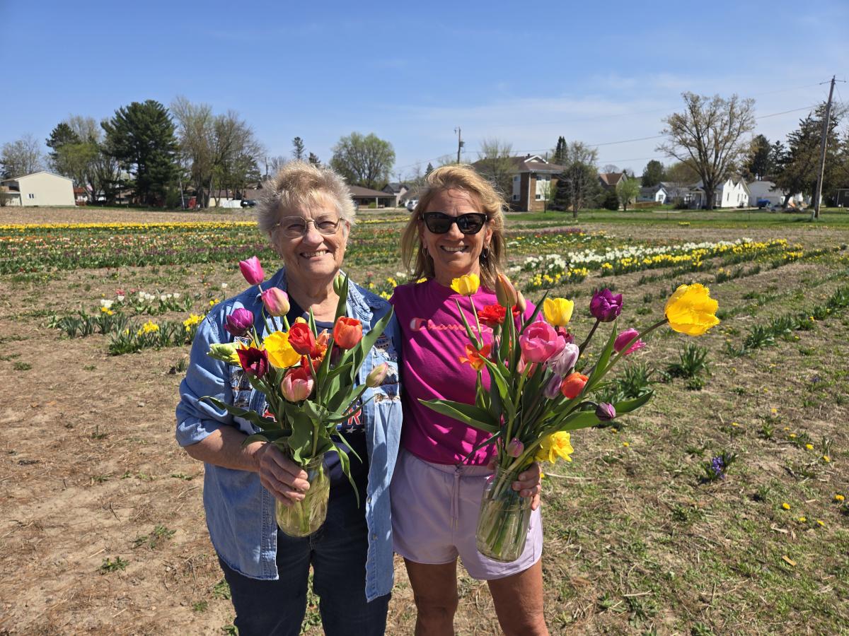 Two ladies holding their tulip bouquets