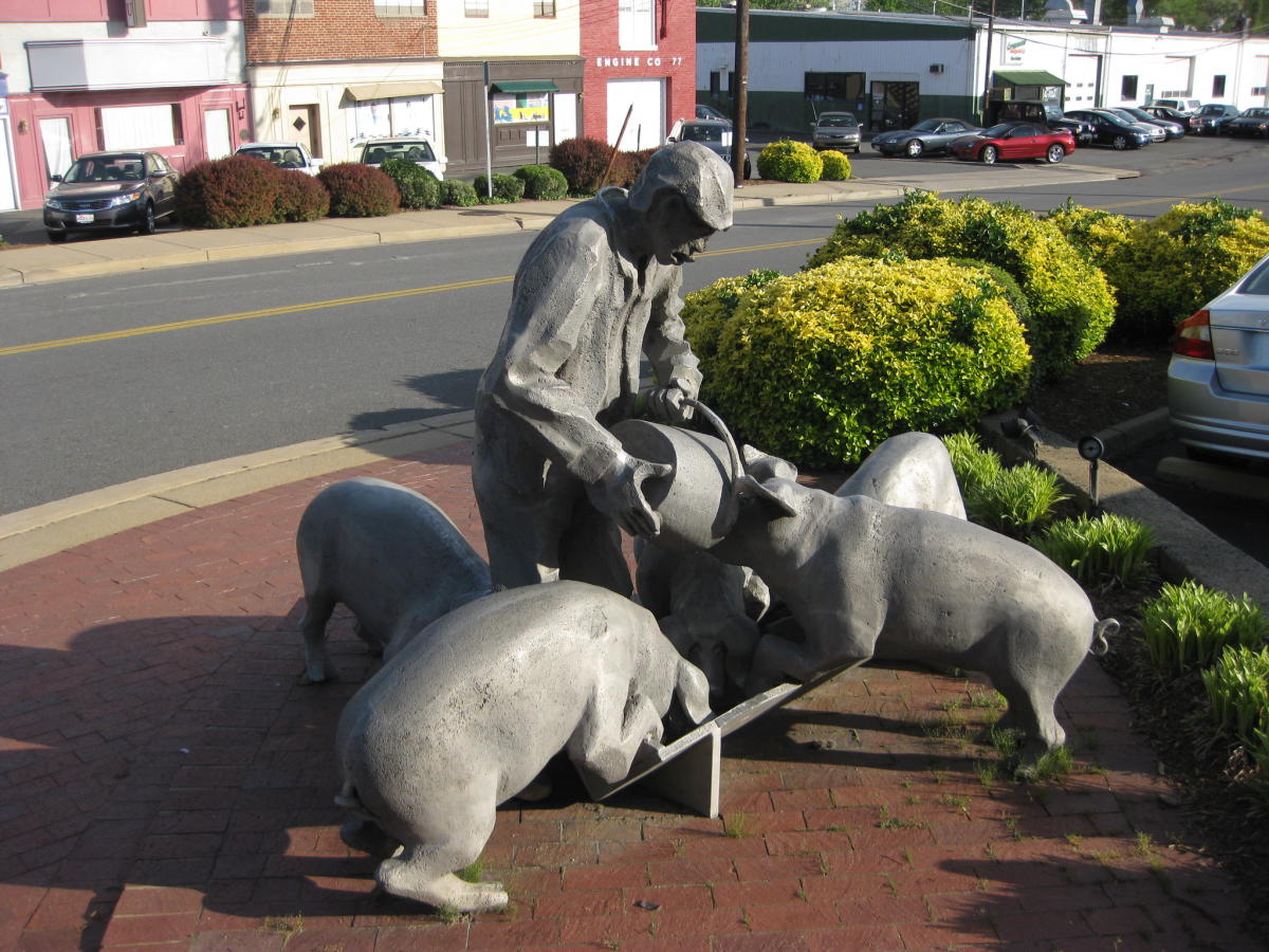 Man Feeding Pigs statue in Falls Church, VA