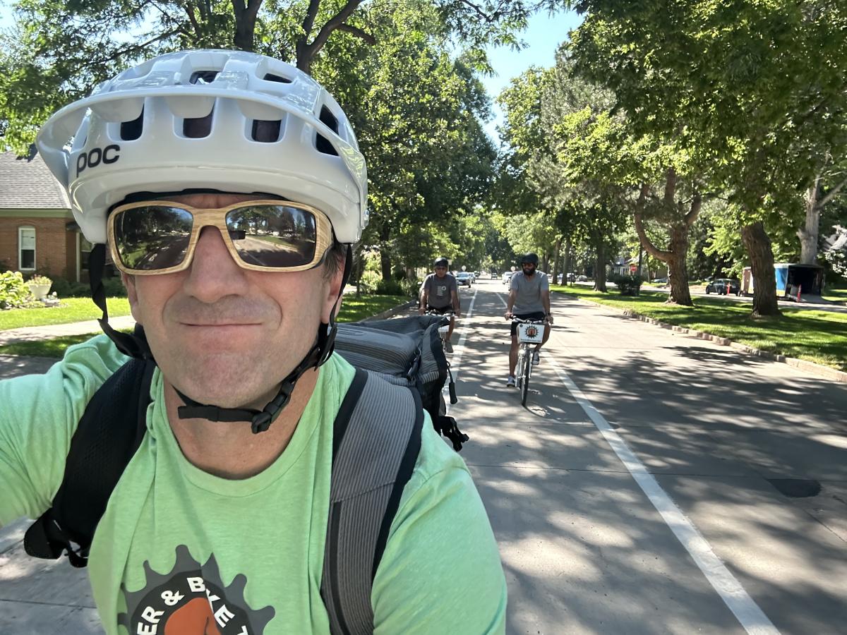 Selfie of bike guide leading two people on a beer and bike tour