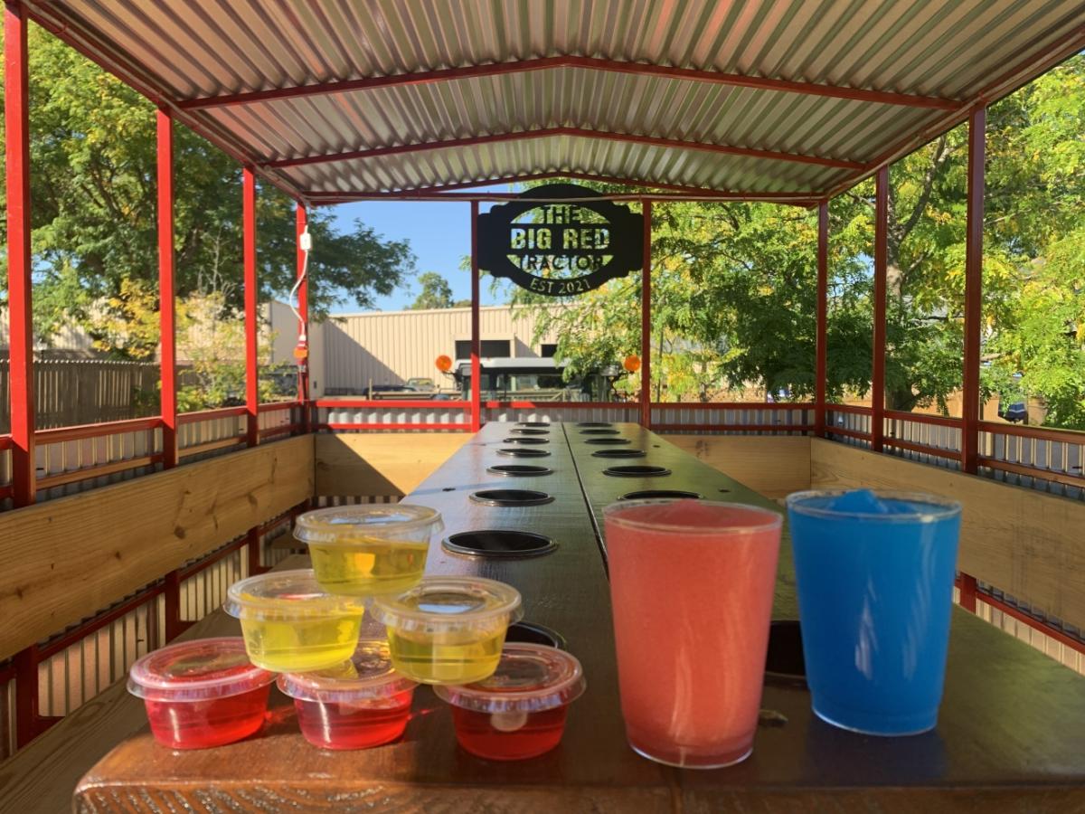 Jello Shots and alcoholic beverages sit on the bar inside of Pedal City's Big Red Tractor