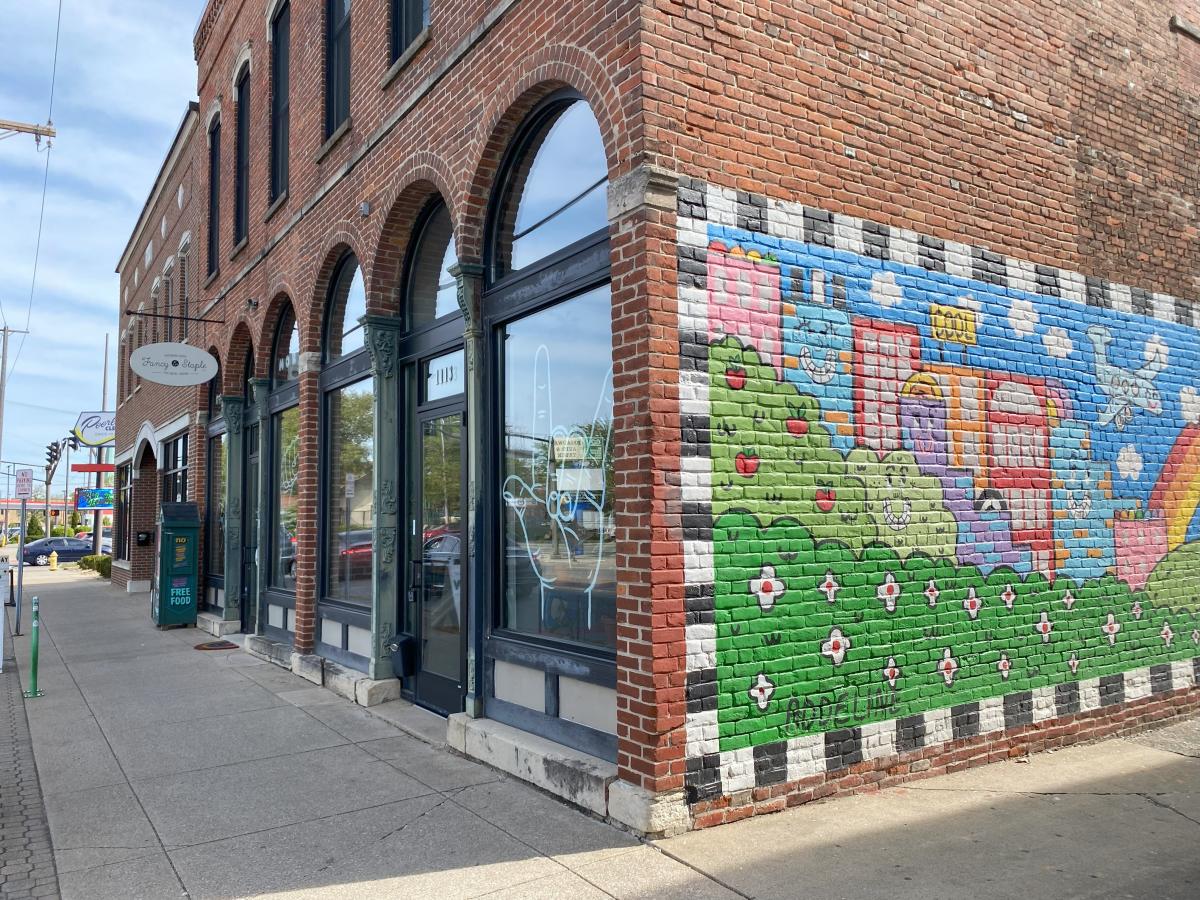 The corner of Fancy Staple with a colorful mural painted on the side.